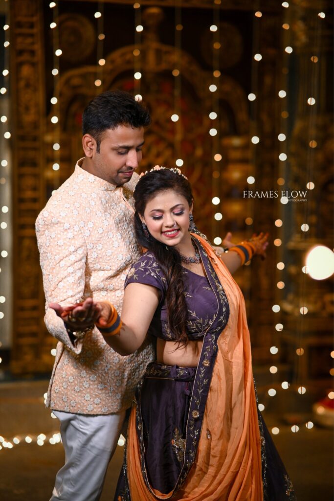 The Telugu Wedding couple stills like titanic pose during their traditional sangeet occasion captured by Framesflow photography in Hyderabad