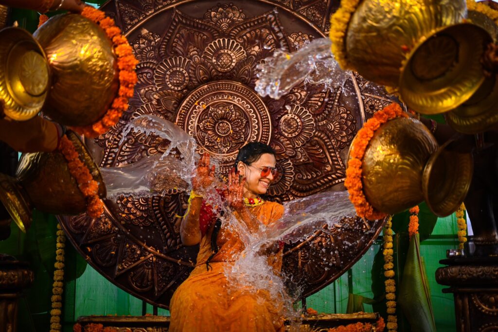 The Telugu bride enjoyous her haldi occassion and poured water by her friends captured by Framesflow photography in Hyderabad