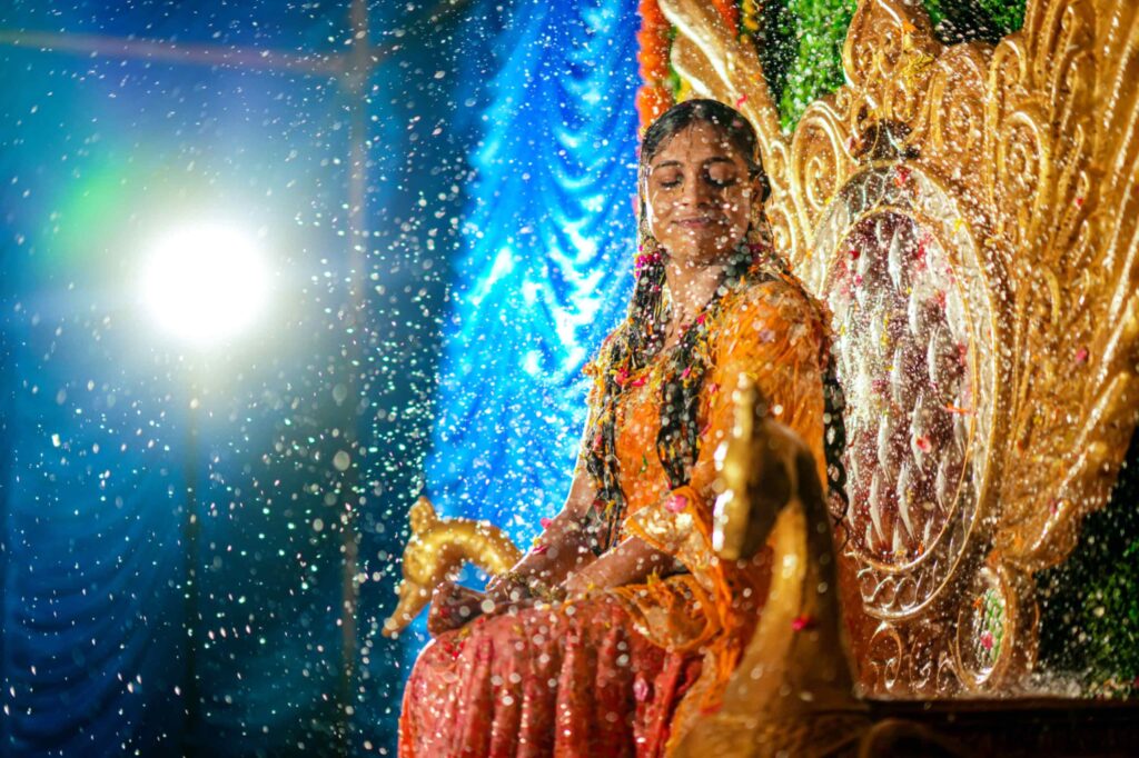 The Telugu bride feels her haldi occasion with the shining of water bubbles captured by Framesflow photography in Hyderabad