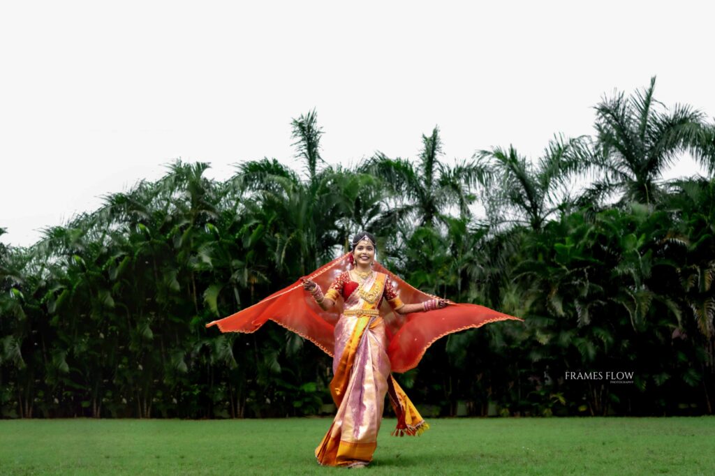 Telugu bride dancing with her dupatta while her wedding ceremony captures by Framesflow photography in Hyderabad