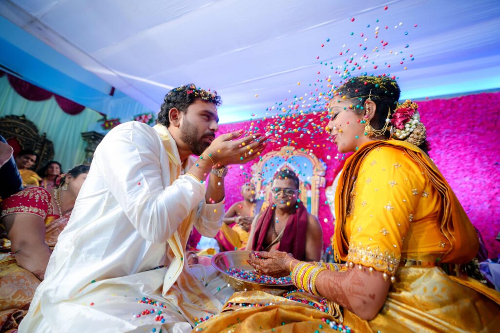 The Telugu wedding couple enjoyous our traditions in their wedding ceremony captured by FramesFlow photography in Hyderabad