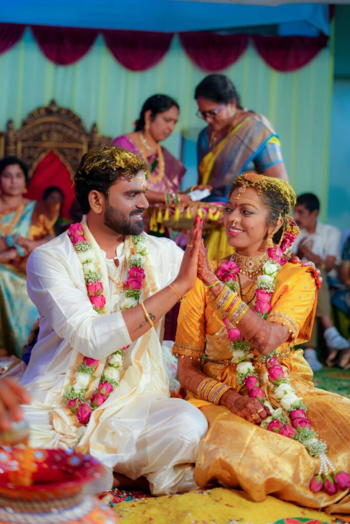 The Telugu wedding couple poses our traditional sign with the lots of happiness in thier wedding ceremony captures by Framesflow in Hyderabad