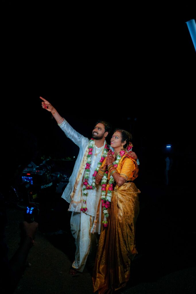 The Telugu wedding couple happily watching Arundhati star captured by FramesFlow photography in Hyderabad